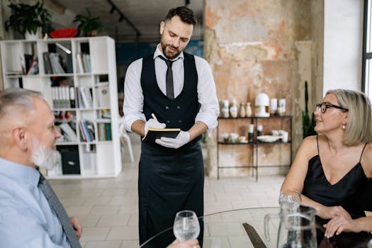 smiling waiter taking orders